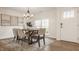 Bright dining room features a modern chandelier and a rustic wood table at 6733 Dorchester Dr, Zionsville, IN 46077