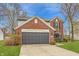 Inviting two-story home with brick accents, a two-car garage, and a lush green lawn at 6733 Dorchester Dr, Zionsville, IN 46077