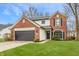 Charming brick and siding home with a well-maintained lawn and attached two-car garage at 6733 Dorchester Dr, Zionsville, IN 46077