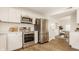 Close up view of stainless steel appliances, white cabinets, and hardwood floors in the kitchen at 6733 Dorchester Dr, Zionsville, IN 46077