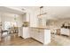 Kitchen includes a view into the dining room and living room with an island for seating at 6733 Dorchester Dr, Zionsville, IN 46077
