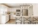 Beautiful kitchen features white cabinets, stainless steel appliances, and a light wood-topped island at 6733 Dorchester Dr, Zionsville, IN 46077