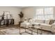Comfortable living room featuring a stylish sofa, glass table, and abundant natural light at 6733 Dorchester Dr, Zionsville, IN 46077