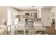 Open-concept living room showcases an updated kitchen with stainless steel appliances and island seating at 6733 Dorchester Dr, Zionsville, IN 46077