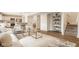 Bright living room with modern decor, flowing into a kitchen and dining area at 6733 Dorchester Dr, Zionsville, IN 46077
