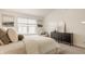 Bedroom with art, plush carpet, upholstered headboard, natural lighting, and dark colored dresser at 6733 Dorchester Dr, Zionsville, IN 46077