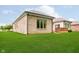 Large, well-maintained backyard with lush green grass and a partial view of the brick home at 7271 Catboat Ct, Fishers, IN 46038