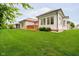 Expansive backyard with lush lawn, wooden decks, and the house visible in the background at 7271 Catboat Ct, Fishers, IN 46038
