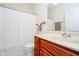 Bathroom featuring vanity with white basin and cabinets, toilet, and shower with curtain at 7271 Catboat Ct, Fishers, IN 46038