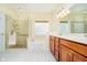 Bright bathroom featuring a glass-enclosed shower, soaking tub, and vanity with double sinks at 7271 Catboat Ct, Fishers, IN 46038