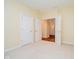Empty bedroom features neutral paint, carpet flooring, and an open doorway at 7271 Catboat Ct, Fishers, IN 46038