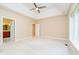 Spacious bedroom with plush carpeting, a ceiling fan, and an ensuite bathroom at 7271 Catboat Ct, Fishers, IN 46038