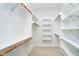 Spacious walk-in closet with built-in shelving and wooden closet rods providing ample storage at 7271 Catboat Ct, Fishers, IN 46038
