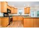 Kitchen featuring stainless steel appliances, wooden cabinets, and stone countertops at 7271 Catboat Ct, Fishers, IN 46038