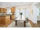 Kitchen with eat in table features stainless steel appliances, wooden cabinets, and stone countertops at 7271 Catboat Ct, Fishers, IN 46038