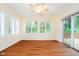 Bright, empty living room with hardwood floors and a sliding door to a deck at 7271 Catboat Ct, Fishers, IN 46038