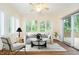 Cozy living room with a ceiling fan, hardwood floors, and access to the outdoor deck at 7271 Catboat Ct, Fishers, IN 46038