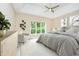 Serene main bedroom featuring tray ceilings and a sun-filled window at 7271 Catboat Ct, Fishers, IN 46038
