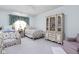 Bright bedroom featuring twin beds with floral bedding, a china cabinet, and pale-blue walls at 7349 Castleton Farms N Dr, Indianapolis, IN 46256