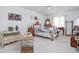 Cozy bedroom with soft carpet, light-blue walls, and various furniture at 7349 Castleton Farms N Dr, Indianapolis, IN 46256