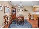 Cozy dining room with hardwood floors, a rustic table set, and a decorative area rug at 7349 Castleton Farms N Dr, Indianapolis, IN 46256