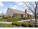 Exterior view of a brick community building with landscaped bushes in front on a sunny day at 7349 Castleton Farms N Dr, Indianapolis, IN 46256