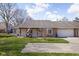 Charming single story home featuring an attached two car garage and a well maintained front yard at 7349 Castleton Farms N Dr, Indianapolis, IN 46256