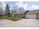 Charming single story home featuring an attached two car garage and a well maintained front yard at 7349 Castleton Farms N Dr, Indianapolis, IN 46256
