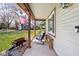 A quaint front porch with comfortable seating, great for enjoying the view of the front yard at 7349 Castleton Farms N Dr, Indianapolis, IN 46256