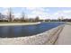 Community pond surrounded by manicured green space and sidewalks perfect for enjoying the outdoors at 7349 Castleton Farms N Dr, Indianapolis, IN 46256