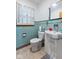 Well-lit bathroom featuring blue tiled walls, toilet, vanity and sink at 791 S Us Highway 31, Whiteland, IN 46184