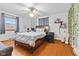 Inviting bedroom with hardwood floors, a ceiling fan, and a large window for natural light at 791 S Us Highway 31, Whiteland, IN 46184