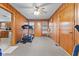Finished bonus room featuring wood paneling, carpeted flooring, and a ceiling fan at 791 S Us Highway 31, Whiteland, IN 46184