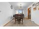 Cozy dining room boasts a wood table with views of the front lawn and a unique modern light fixture at 791 S Us Highway 31, Whiteland, IN 46184