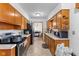 Efficient kitchen layout with wooden cabinets, tile backsplash, standard appliances, and direct access to the dining area at 791 S Us Highway 31, Whiteland, IN 46184