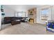 Spacious living room features neutral carpet, stone fireplace, bright windows, and a brown leather sofa at 791 S Us Highway 31, Whiteland, IN 46184