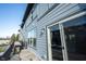 View of balcony featuring gray siding, sliding glass door, wood decking, and black metal railing at 8194 Bostic Ct, Fishers, IN 46038