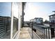 Side angle of a balcony with views of surrounding modern townhomes and black metal railings at 8194 Bostic Ct, Fishers, IN 46038