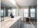 Bright bathroom featuring a walk-in shower, double sinks, and ample counter space at 8194 Bostic Ct, Fishers, IN 46038