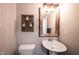 Charming powder room featuring rustic mirror and decorative wall sconce at 8194 Bostic Ct, Fishers, IN 46038