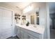Bright bathroom with double sink vanity, stylish shelves, and a large mirror at 8194 Bostic Ct, Fishers, IN 46038