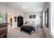 Well-lit bedroom with a queen bed, dark wood furniture, and ample natural light at 8194 Bostic Ct, Fishers, IN 46038