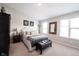 Cozy bedroom with a queen-sized bed, bench seat, and natural light from windows at 8194 Bostic Ct, Fishers, IN 46038