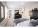 Bright bedroom featuring a fireplace, soft carpet, and a door to the bathroom at 8194 Bostic Ct, Fishers, IN 46038