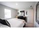 Well-lit bedroom featuring a large bed, dresser and comfortable chair at 8194 Bostic Ct, Fishers, IN 46038