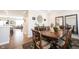 Elegant dining area with wood table, chairs and view of a living space at 8194 Bostic Ct, Fishers, IN 46038