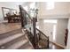 View of the entryway from the second floor landing, showing stairs, and living room at 8194 Bostic Ct, Fishers, IN 46038
