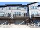 Exterior view of modern townhomes with garage, balconies, and neutral color scheme at 8194 Bostic Ct, Fishers, IN 46038