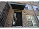 Close-up of a modern front door with stylish black finish and hardware, set in brick facade at 8194 Bostic Ct, Fishers, IN 46038