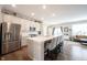 Modern kitchen featuring stainless steel appliances, a center island with bar seating, and hardwood floors at 8194 Bostic Ct, Fishers, IN 46038